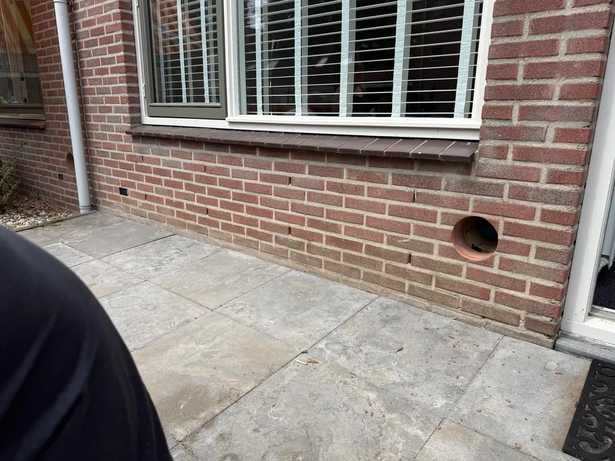 Betonboringen Boxtel &mdash; doorvoer laag in een bakstenen gevel naast het terras